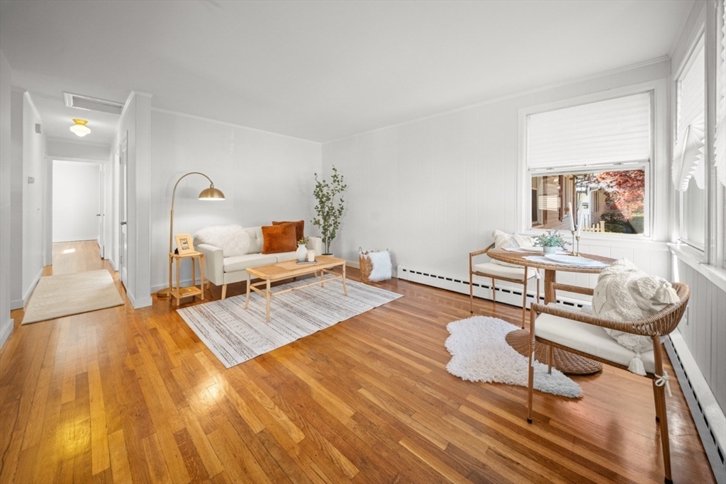1180 Main Street, Unit 1 Waltham, MA 02451 - Photo 5 of 30 a bedroom with a bed and wooden floor