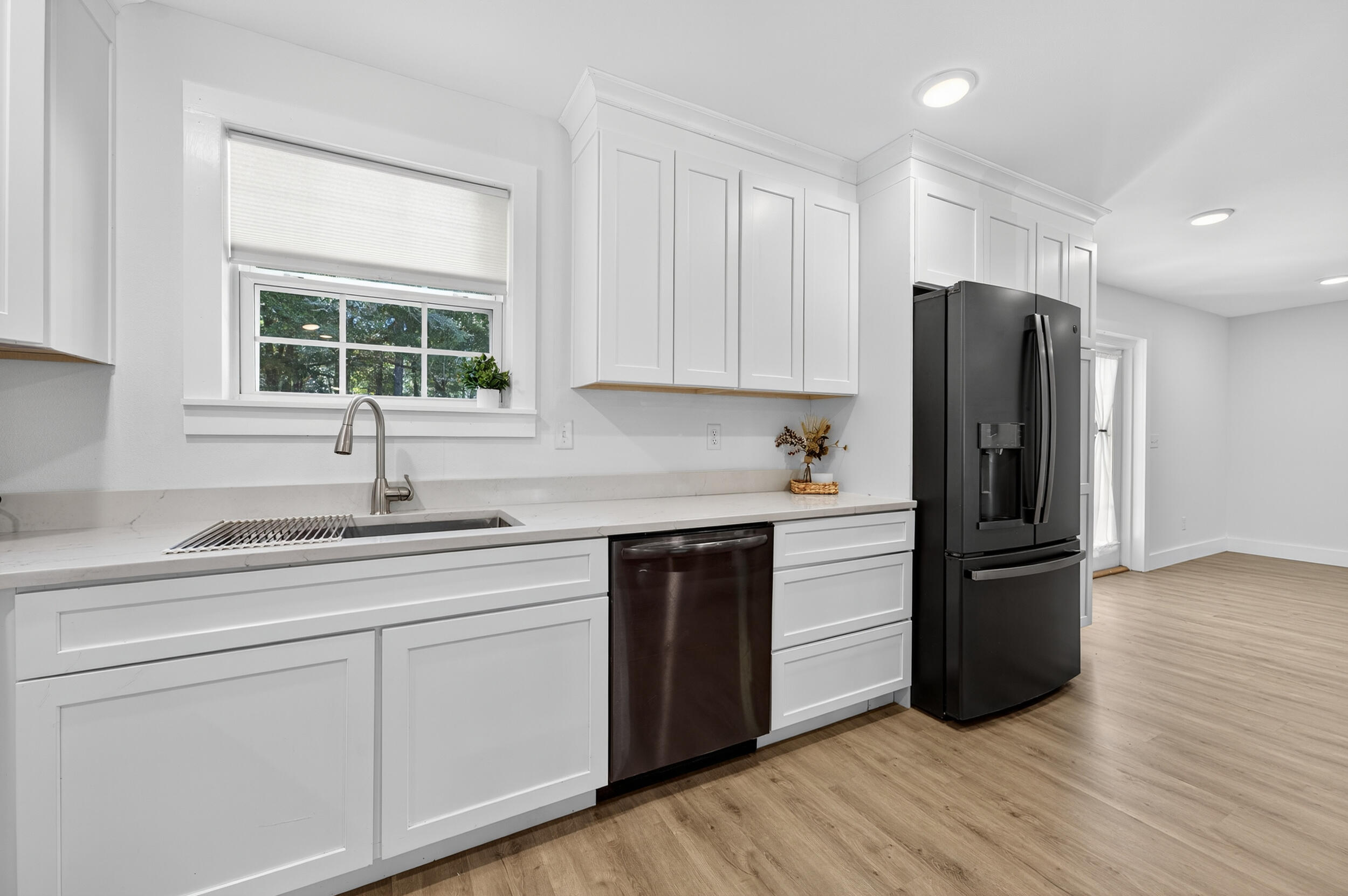 4734 Haybarn Road Holt, FL 32564 - Photo 17 of 54 a kitchen with a refrigerator and white cabinets