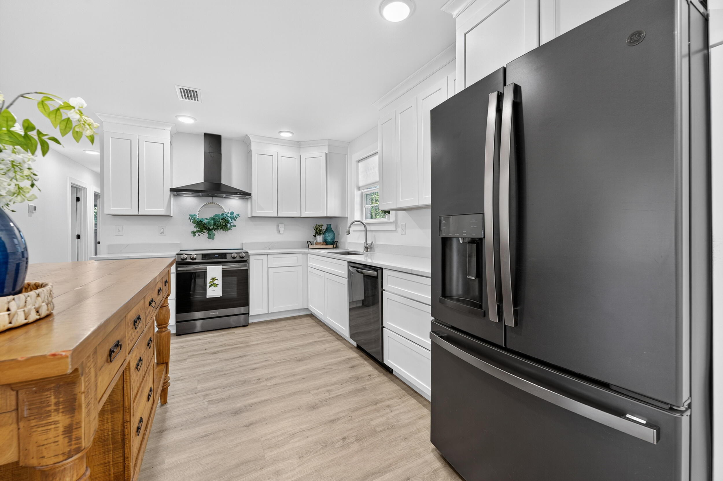 4734 Haybarn Road Holt, FL 32564 - Photo 20 of 56 a kitchen with stainless steel appliances a refrigerator sink and white cabinets