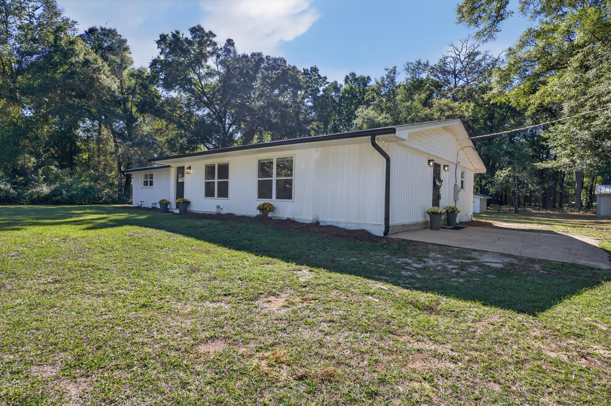 4734 Haybarn Road Holt, FL 32564 - Photo 2 of 54 a view of a house with backyard and trees