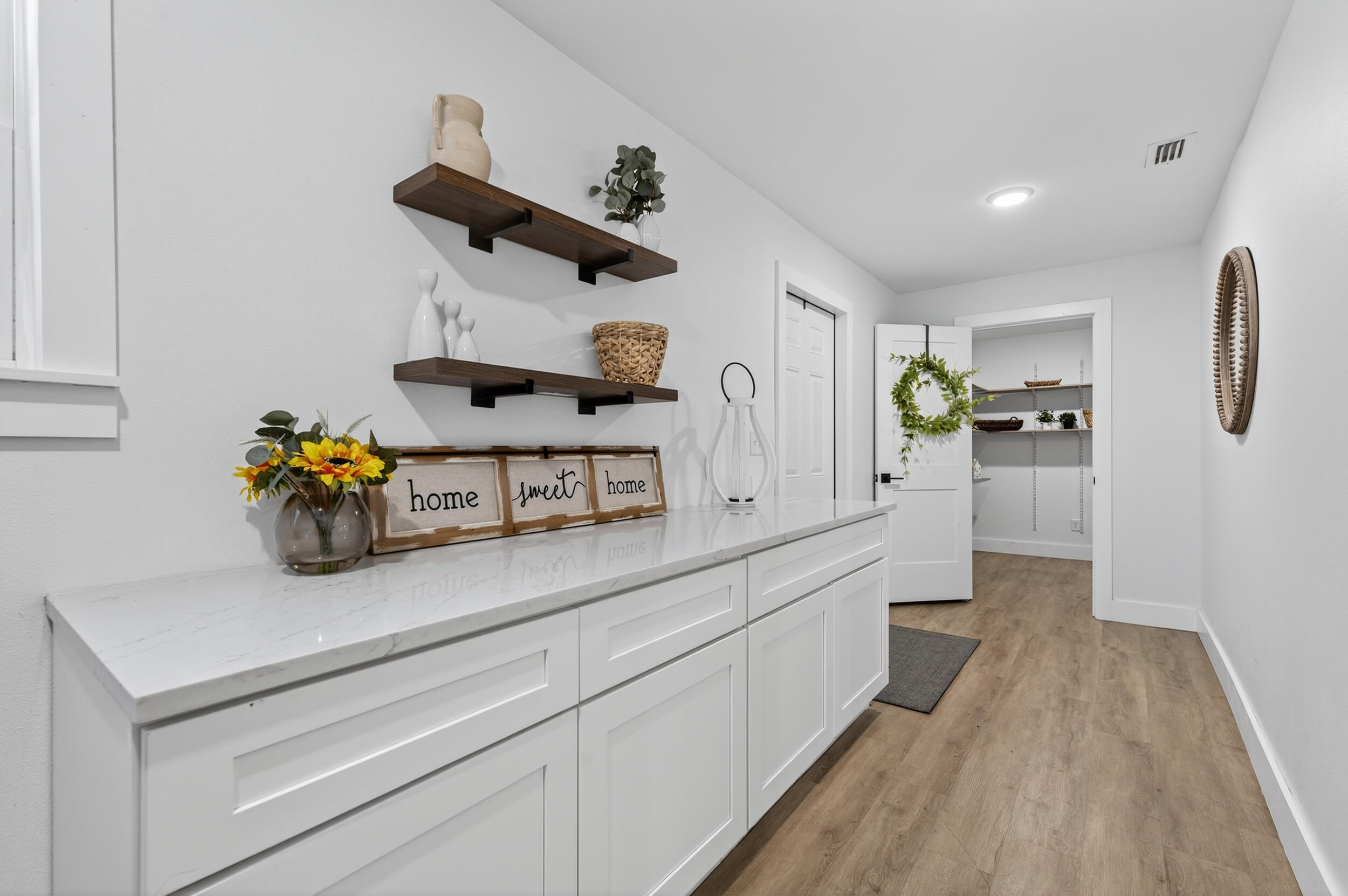4734 Haybarn Road Holt, FL 32564 - Photo 23 of 56 a kitchen with stainless steel appliances granite countertop a sink and wooden floors