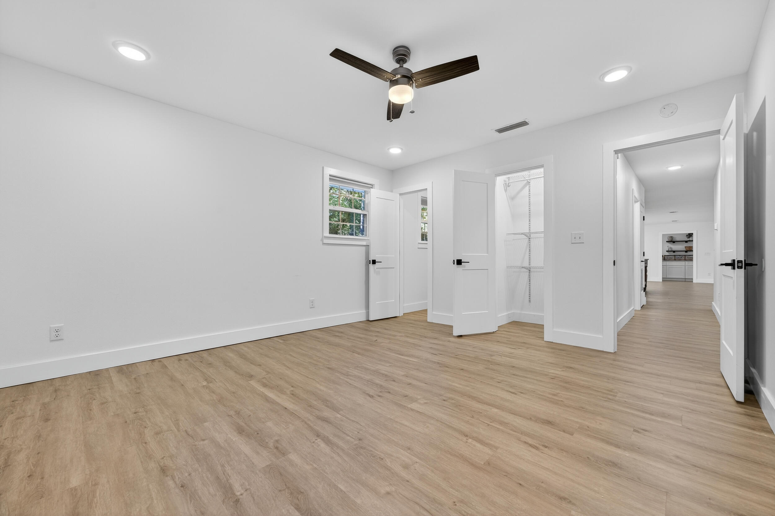 4734 Haybarn Road Holt, FL 32564 - Photo 27 of 56 an empty room with wooden floor and a ceiling fan