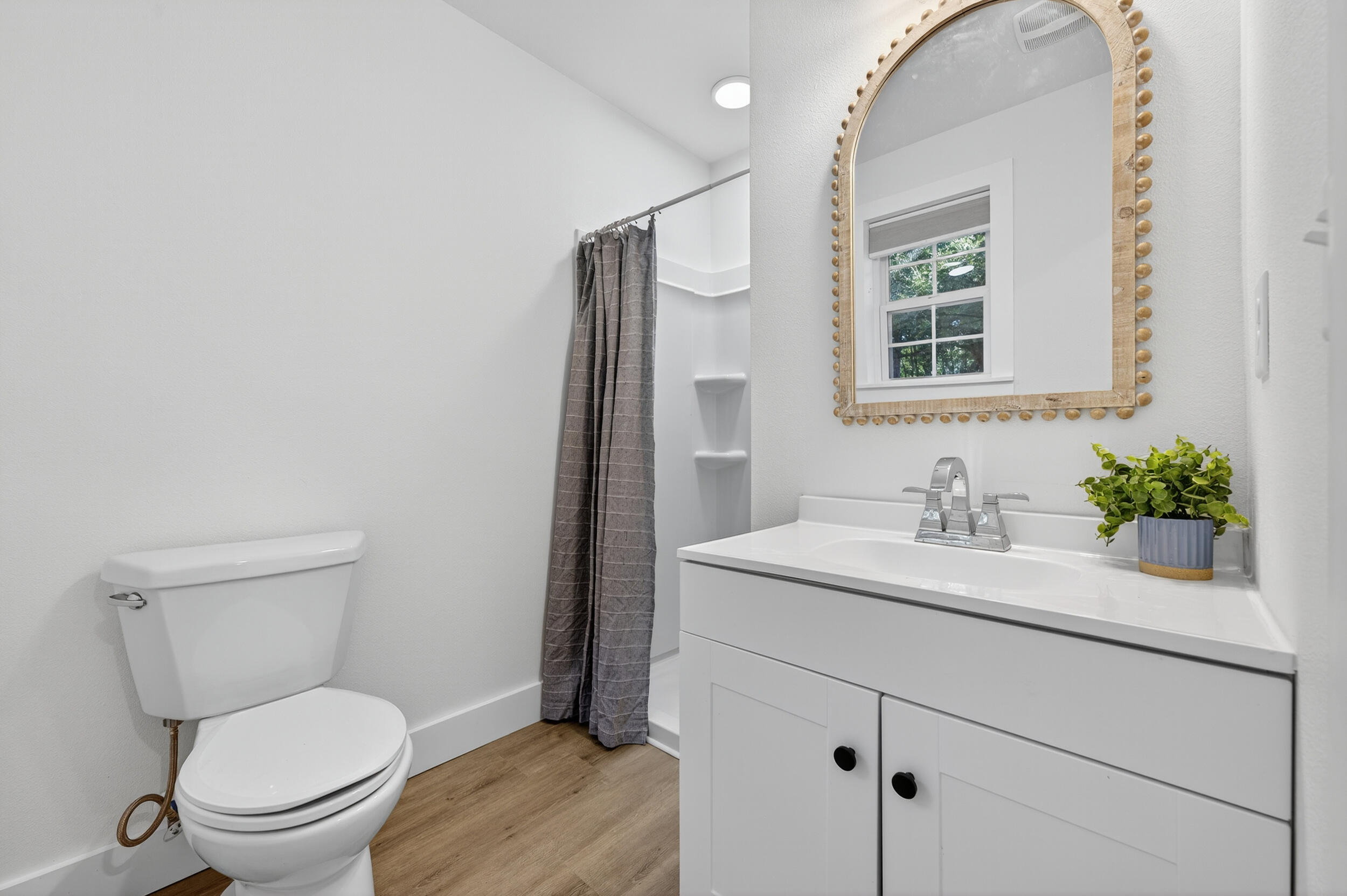 4734 Haybarn Road Holt, FL 32564 - Photo 29 of 56 a bathroom with a toilet sink a mirror and vanity