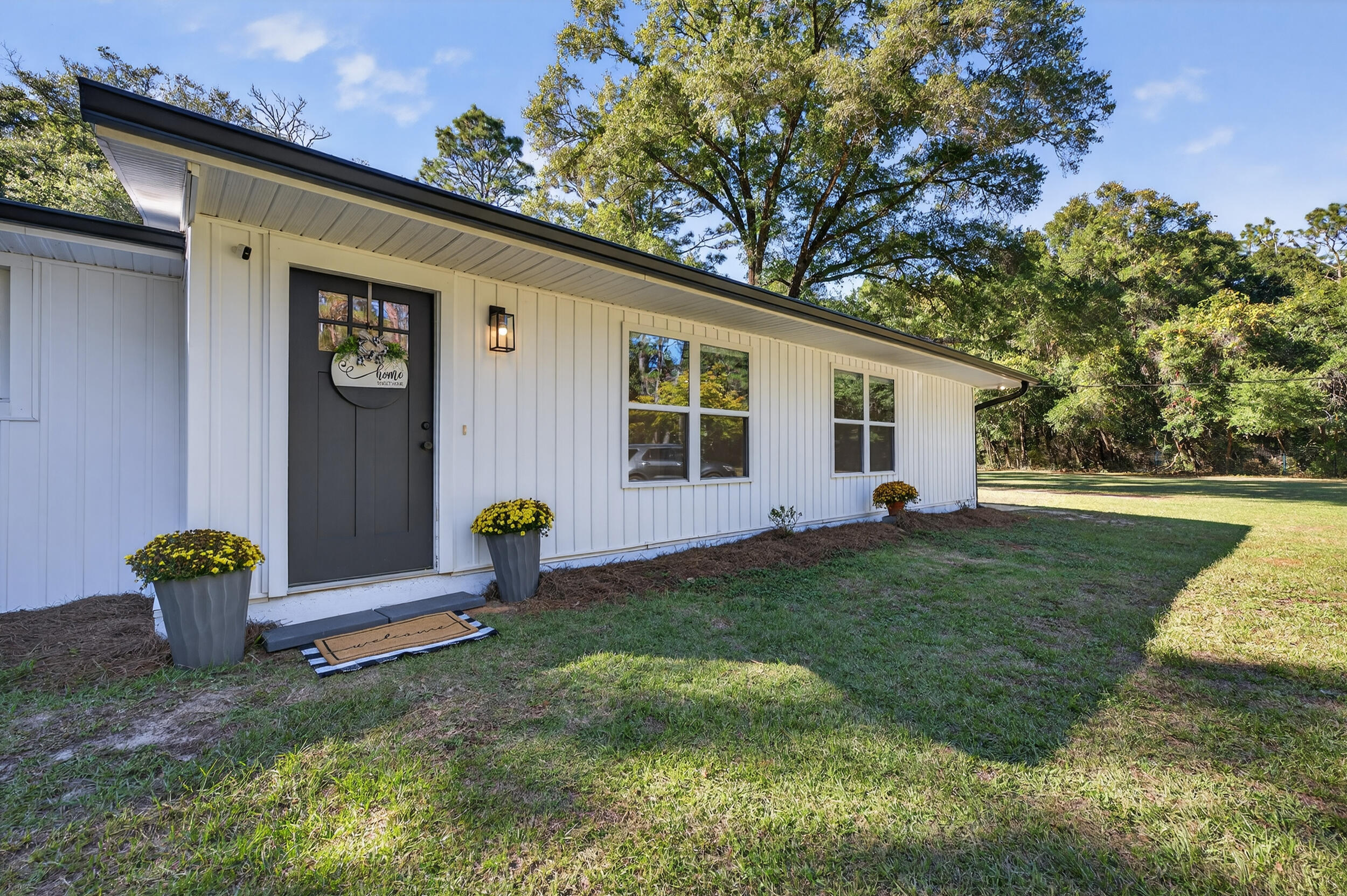 4734 Haybarn Road Holt, FL 32564 - Photo 3 of 54 a backyard of a house with table and chairs