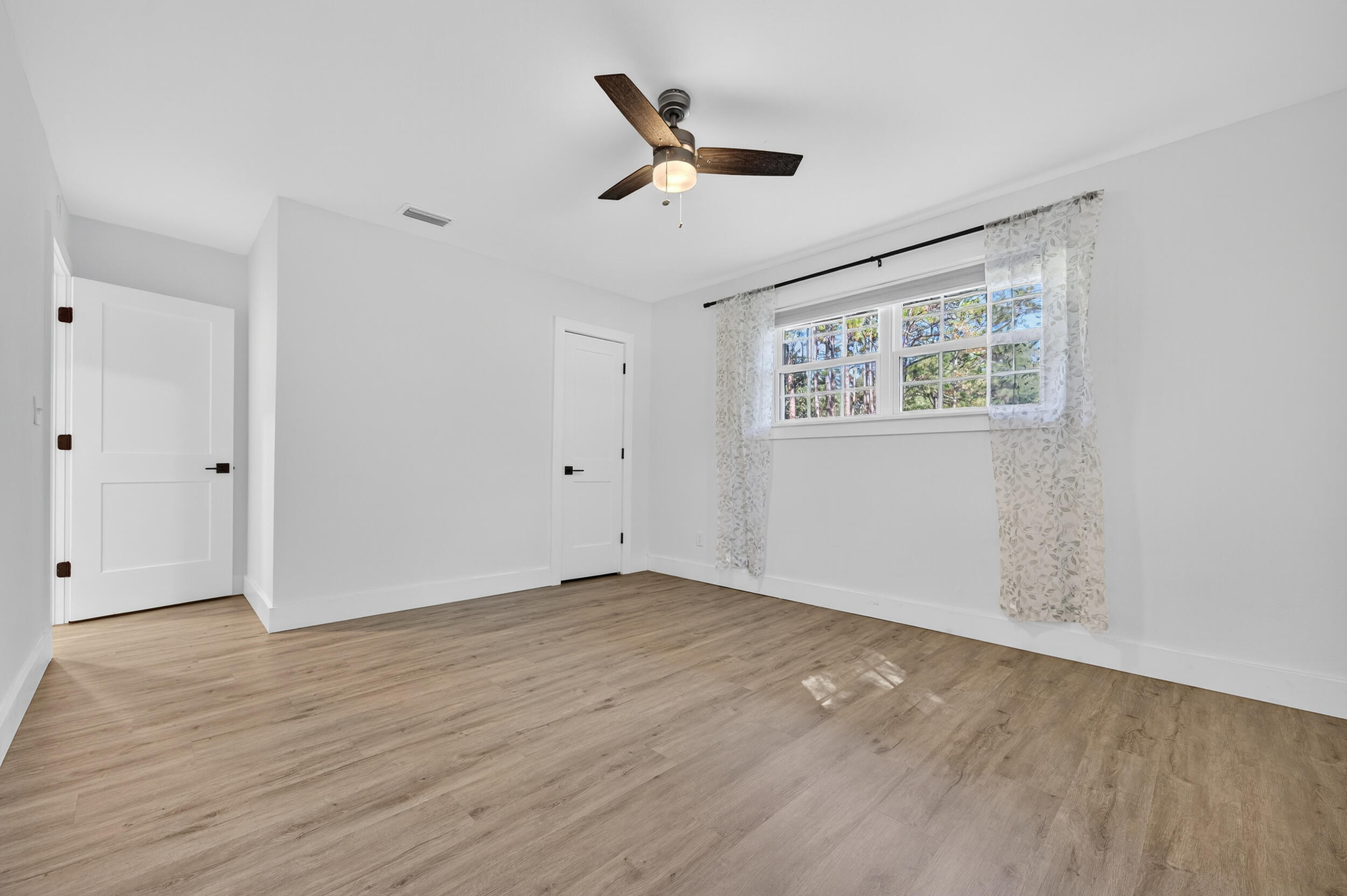 4734 Haybarn Road Holt, FL 32564 - Photo 32 of 56 wooden floor in an empty room