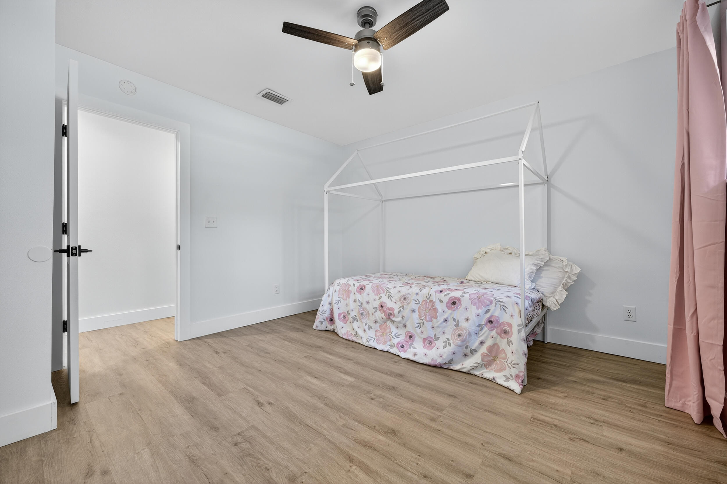 4734 Haybarn Road Holt, FL 32564 - Photo 33 of 54 a bedroom with a bed and wooden floor