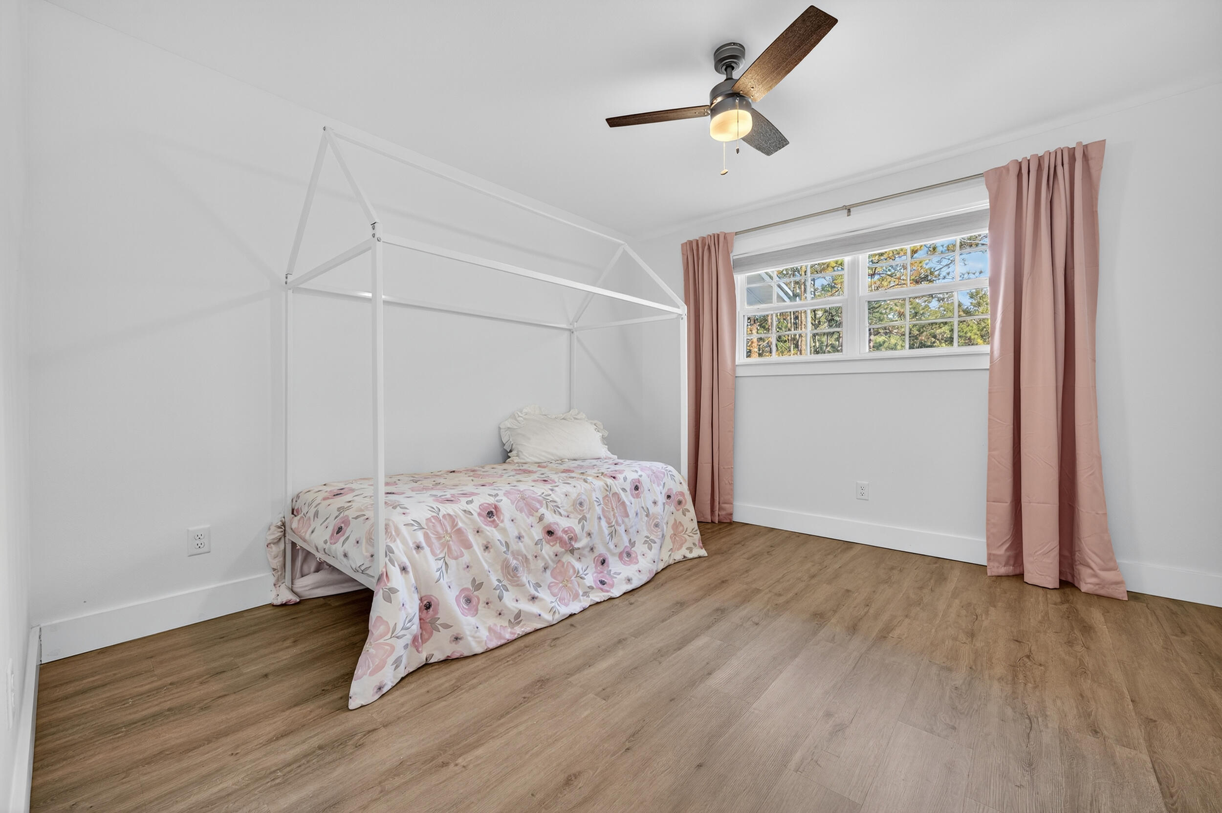 4734 Haybarn Road Holt, FL 32564 - Photo 34 of 56 a bedroom with a bed and wooden floor