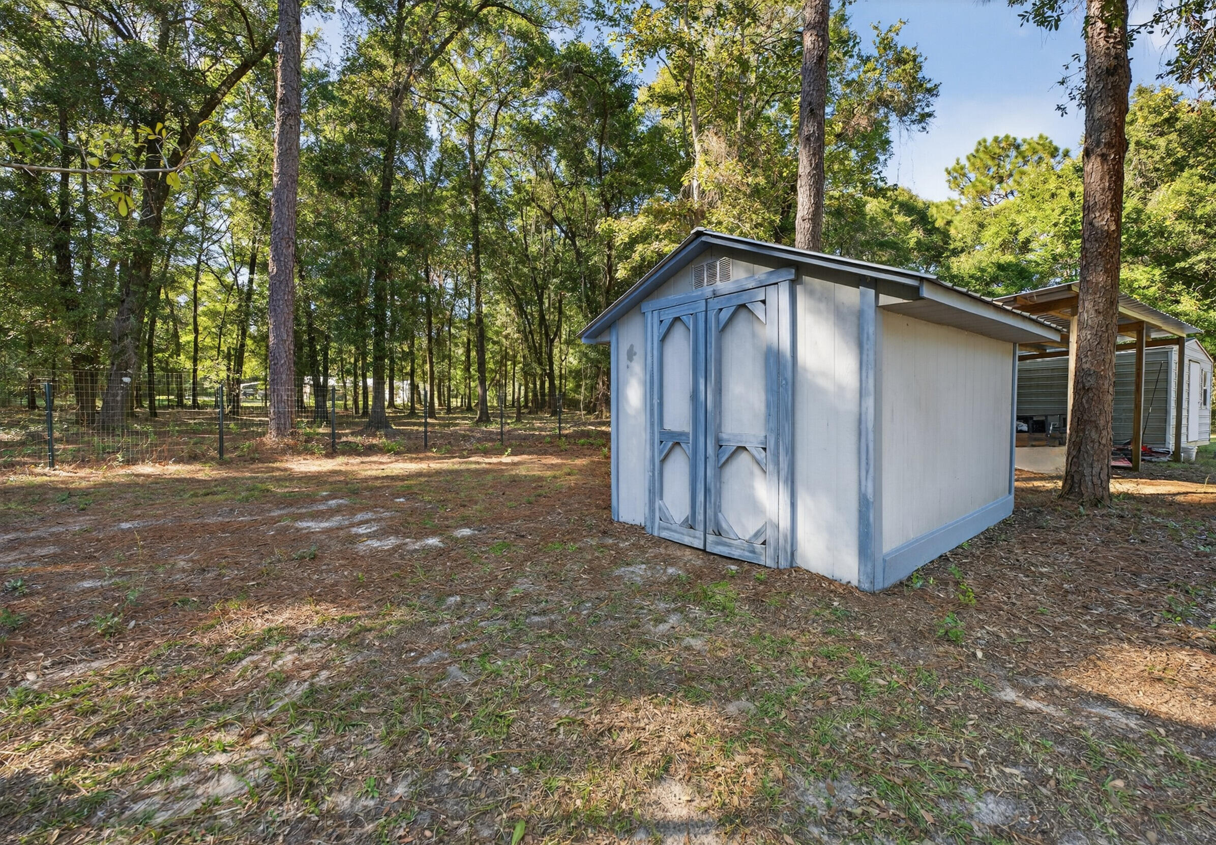 4734 Haybarn Road Holt, FL 32564 - Photo 43 of 54 a view of a backyard with large trees