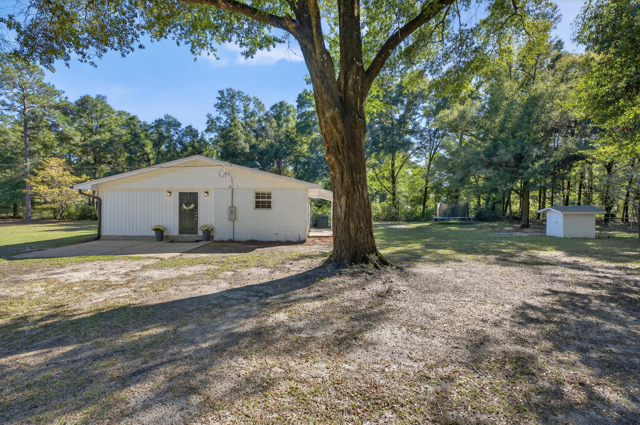 4734 Haybarn Road Holt, FL 32564 - Photo 46 of 54 a view of a house with backyard and a tree