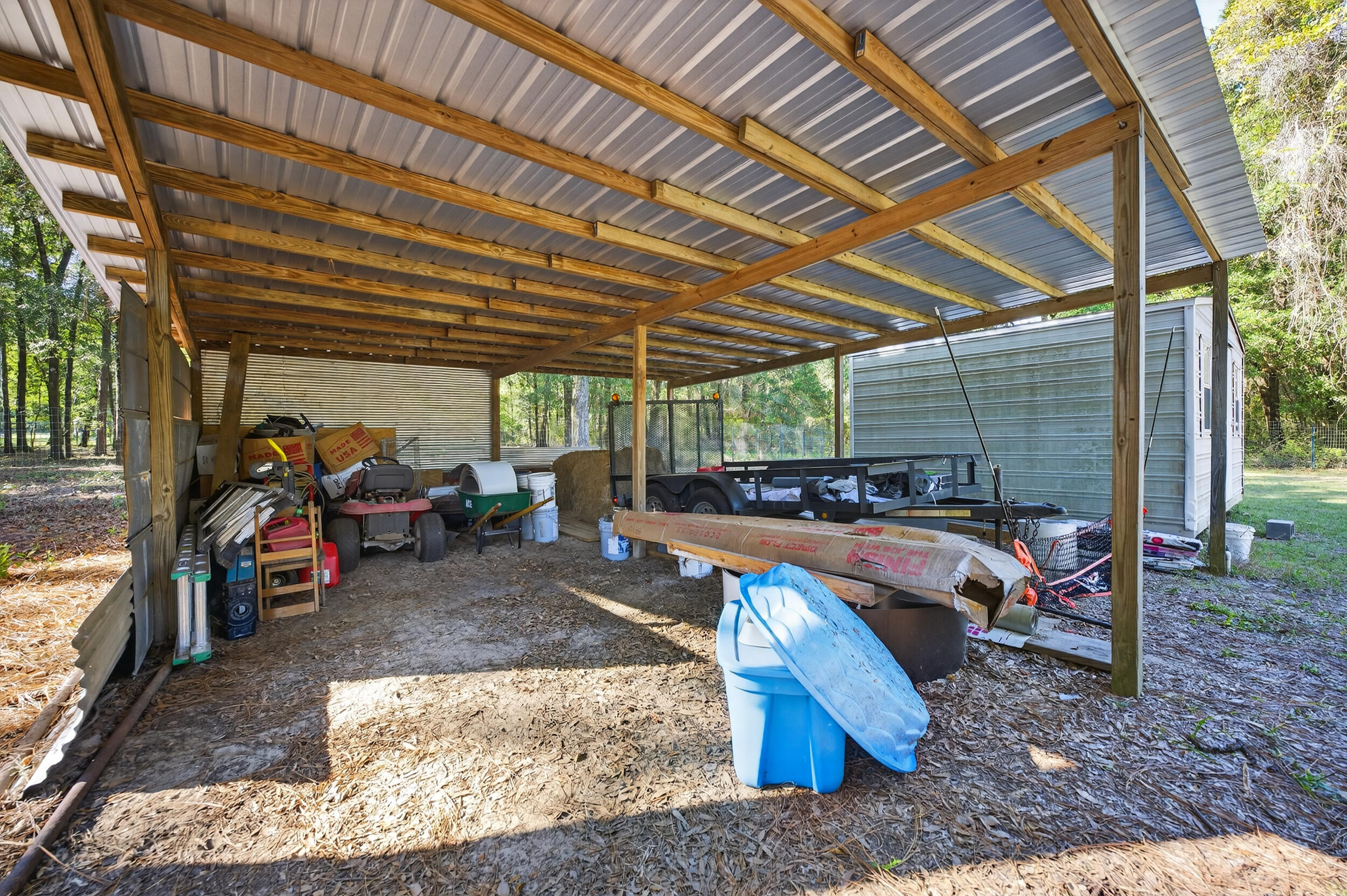 4734 Haybarn Road Holt, FL 32564 - Photo 46 of 56 a view of a backyard with table and chairs under an umbrella