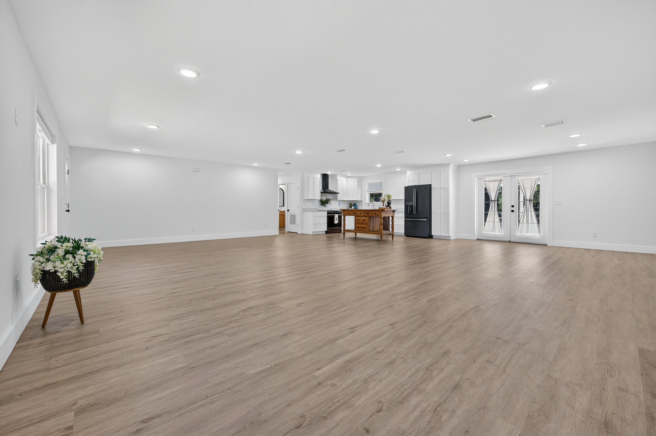 4734 Haybarn Road Holt, FL 32564 - Photo 7 of 54 a view of a living room a kitchen with furniture and wooden floor