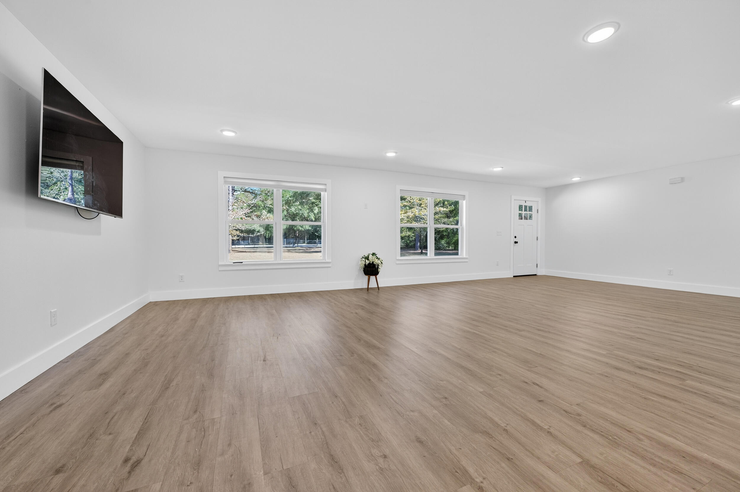 4734 Haybarn Road Holt, FL 32564 - Photo 8 of 54 an empty room with wooden floor and windows