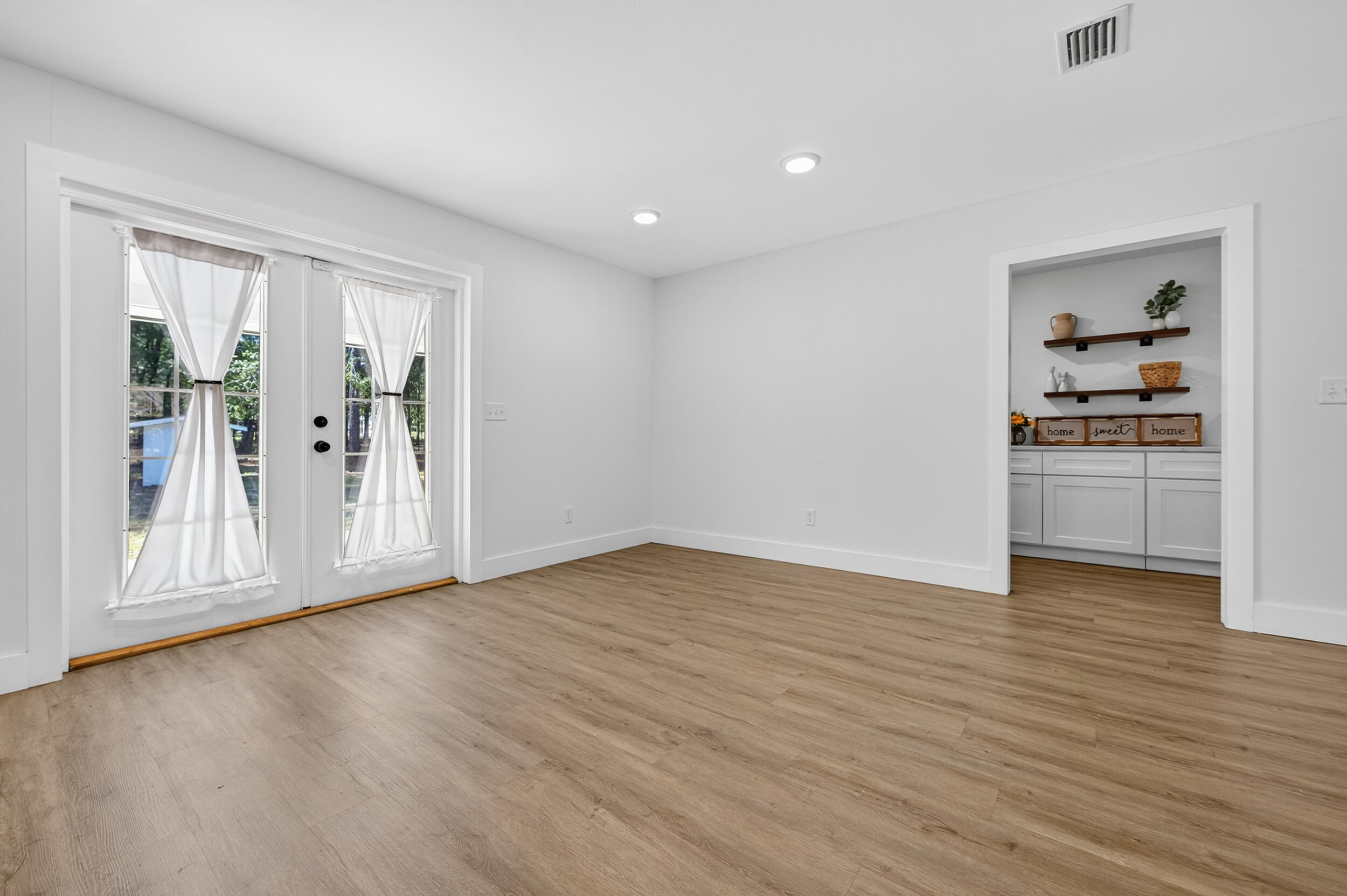4734 Haybarn Road Holt, FL 32564 - Photo 9 of 54 a view of empty room with wooden floor