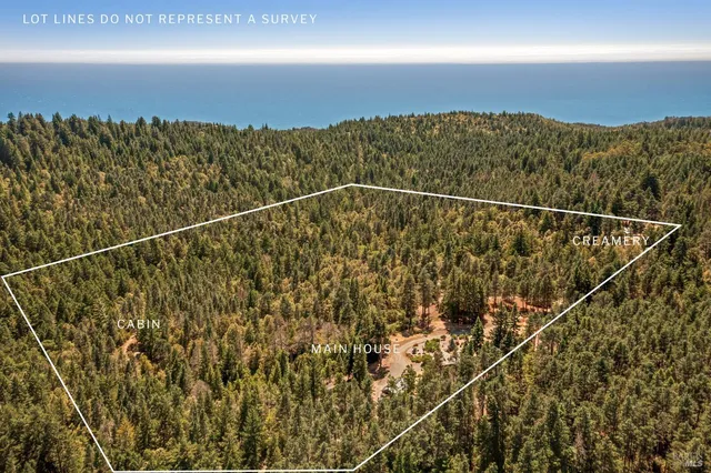 a backyard of a house with fountain table and chairs potted plants