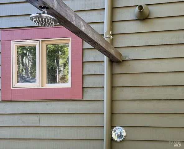 a view of a roof deck with wooden fence and plants