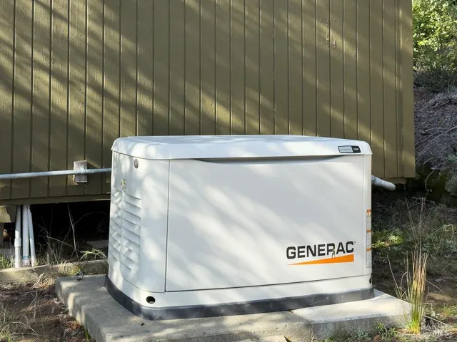 a front view of house with yard and trees around