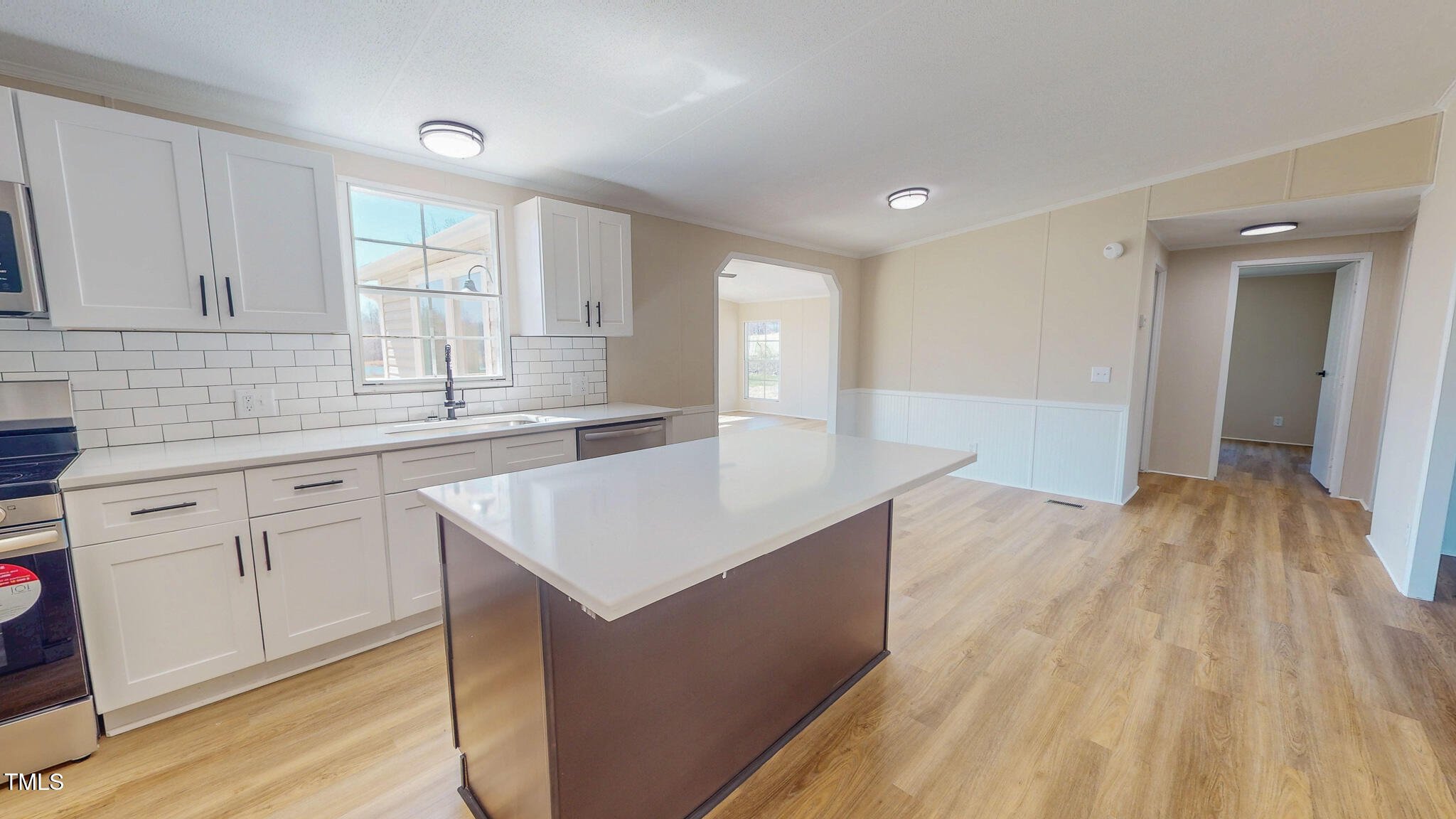 210 Holloway Road Roxboro, NC 27573 - Photo 11 of 44 a kitchen with granite countertop a sink dishwasher a stove and white cabinets with wooden floor