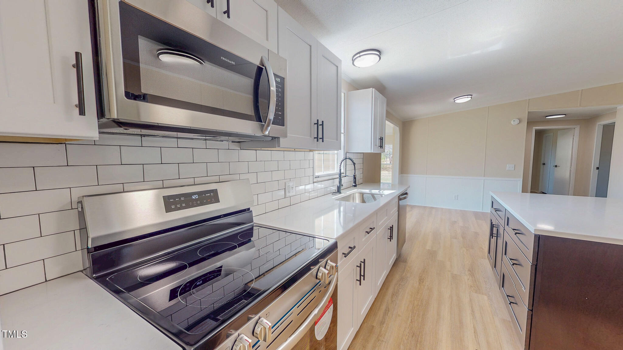 210 Holloway Road Roxboro, NC 27573 - Photo 12 of 44 a kitchen with a stove a sink and a microwave