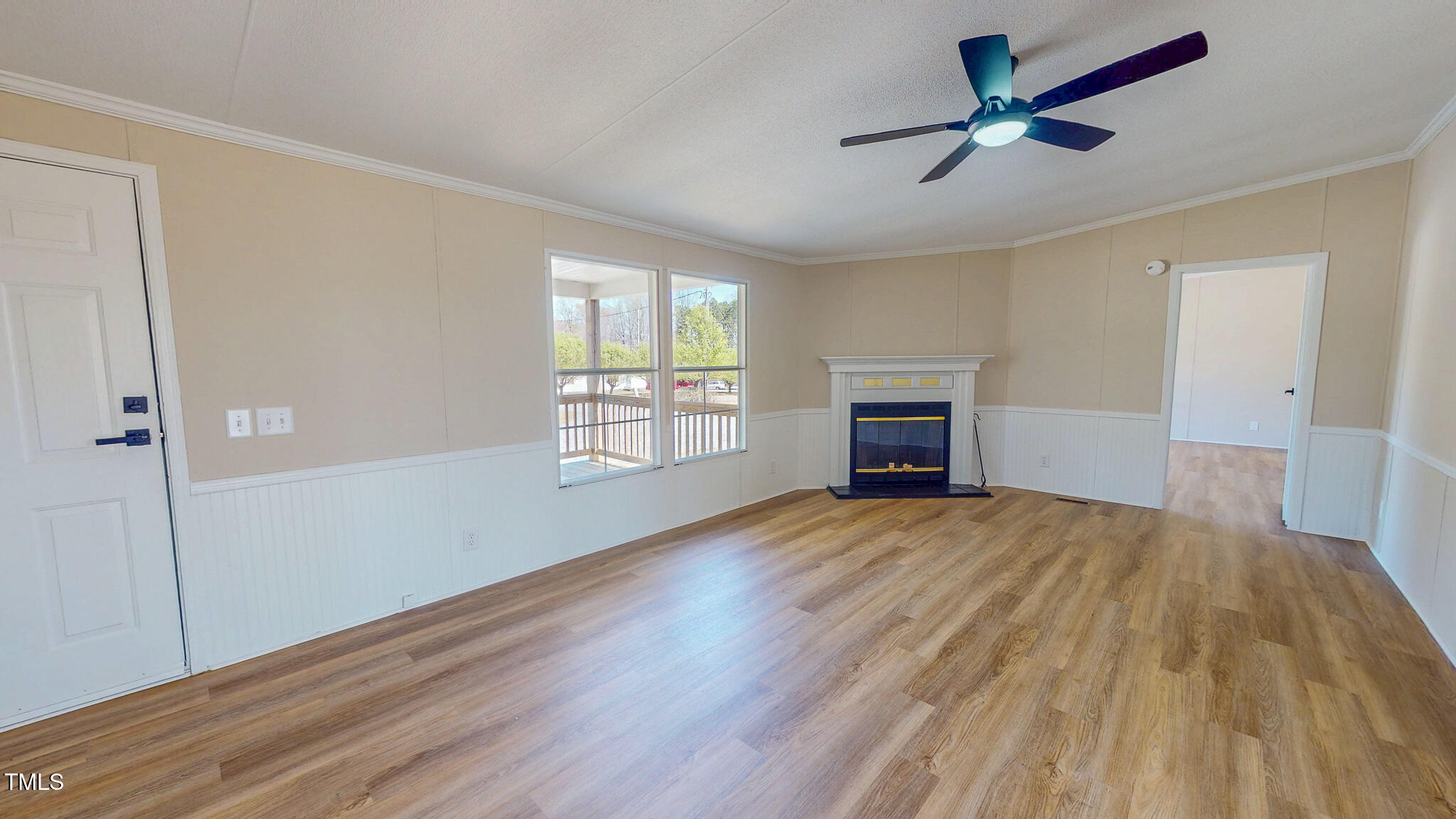 210 Holloway Road Roxboro, NC 27573 - Photo 15 of 44 an empty room with wooden floor fireplace and windows
