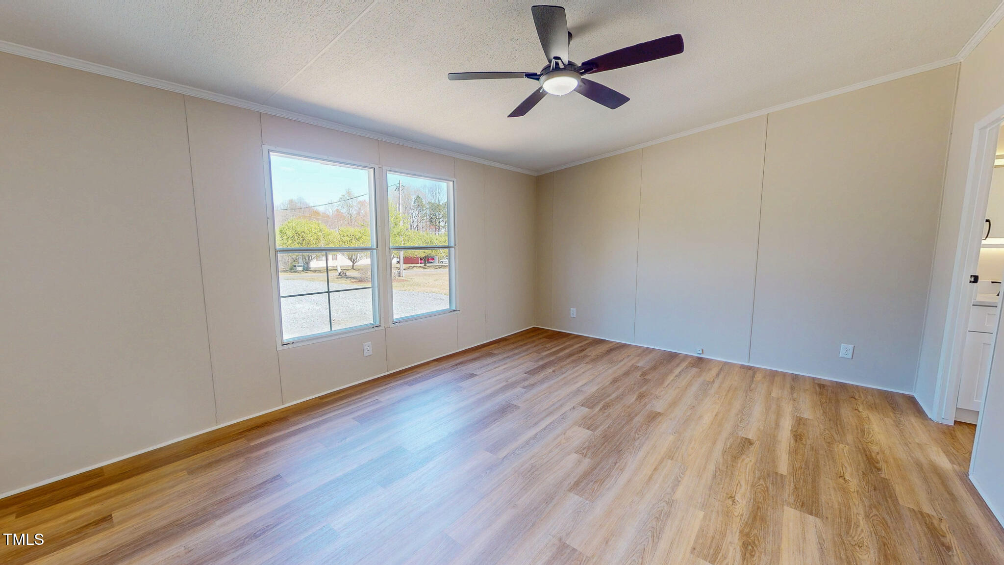 210 Holloway Road Roxboro, NC 27573 - Photo 17 of 44 a view of empty room with wooden floor and fan