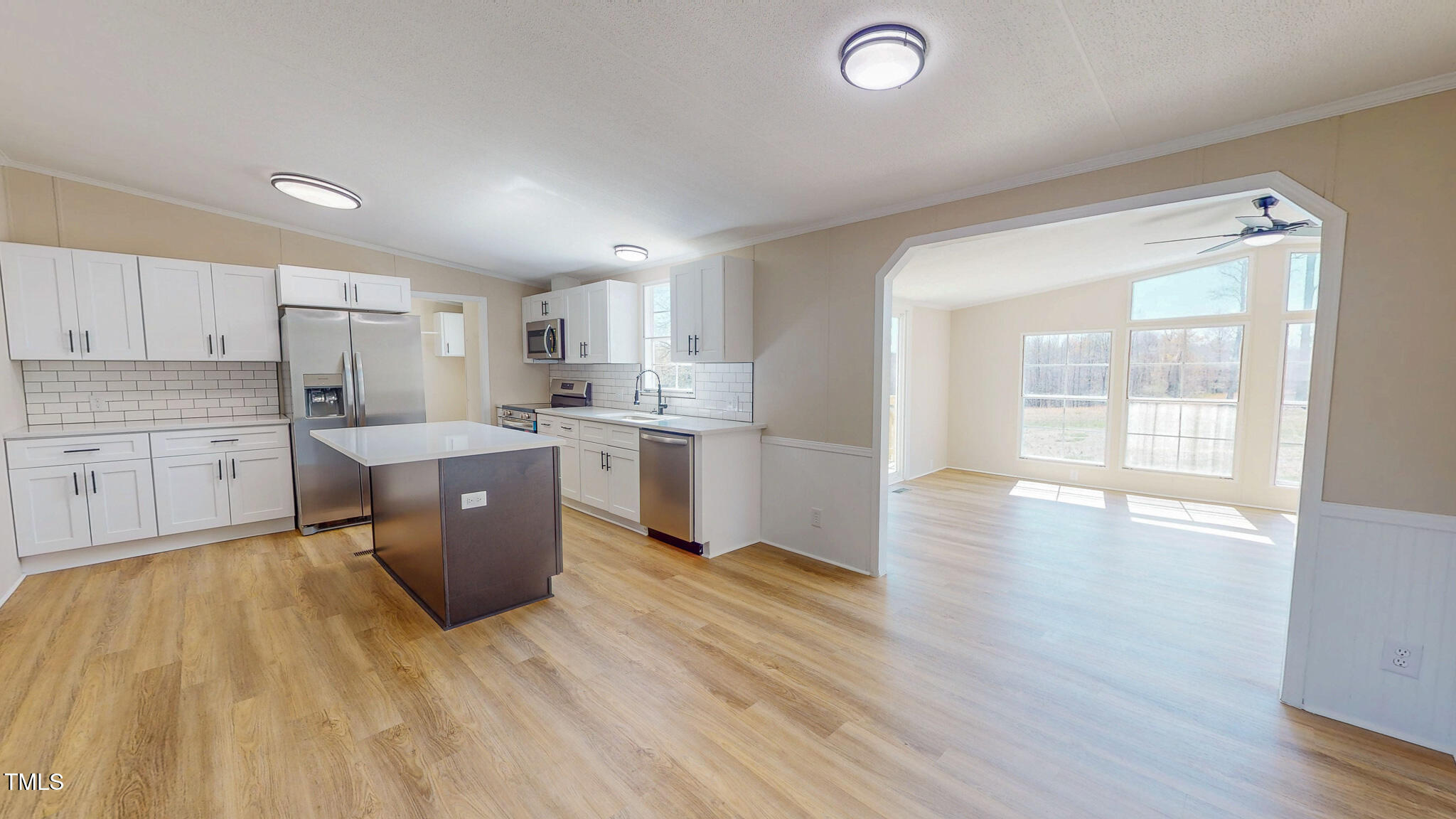 210 Holloway Road Roxboro, NC 27573 - Photo 3 of 44 a kitchen with wooden floors and white cabinets