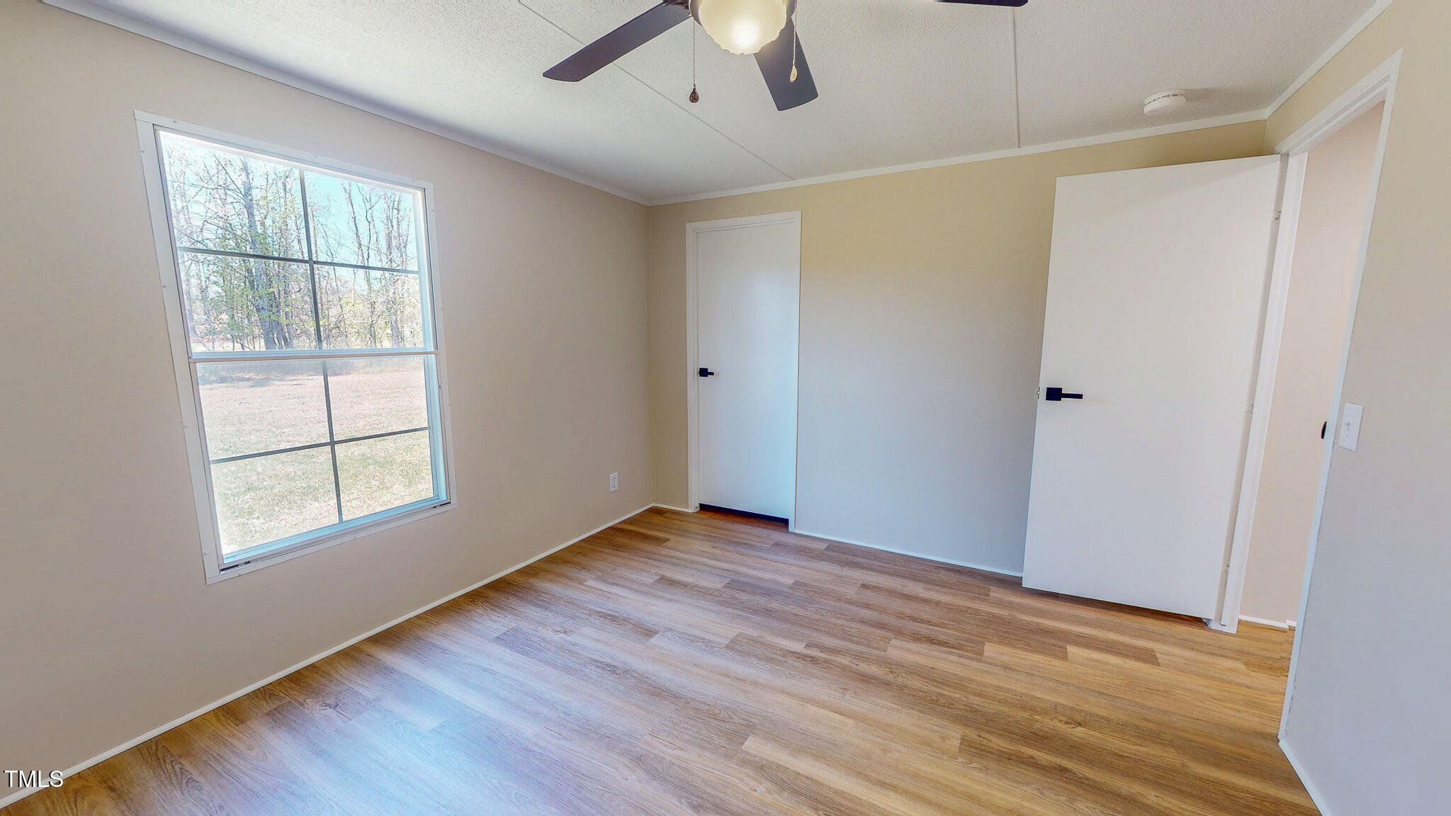 210 Holloway Road Roxboro, NC 27573 - Photo 33 of 44 a view of an empty room with wooden floor and a window
