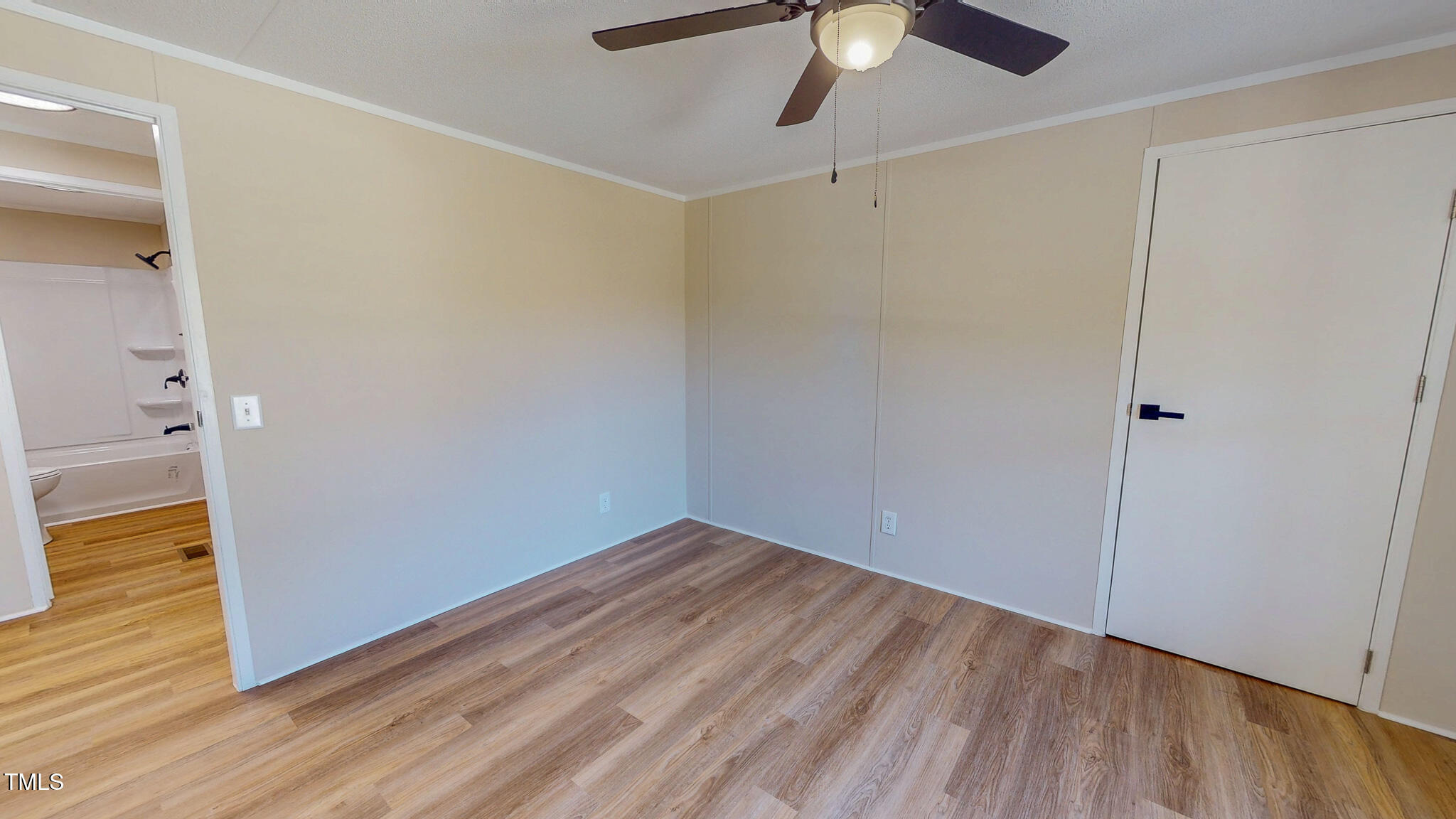 210 Holloway Road Roxboro, NC 27573 - Photo 38 of 44 an empty room with wooden floor fan and windows