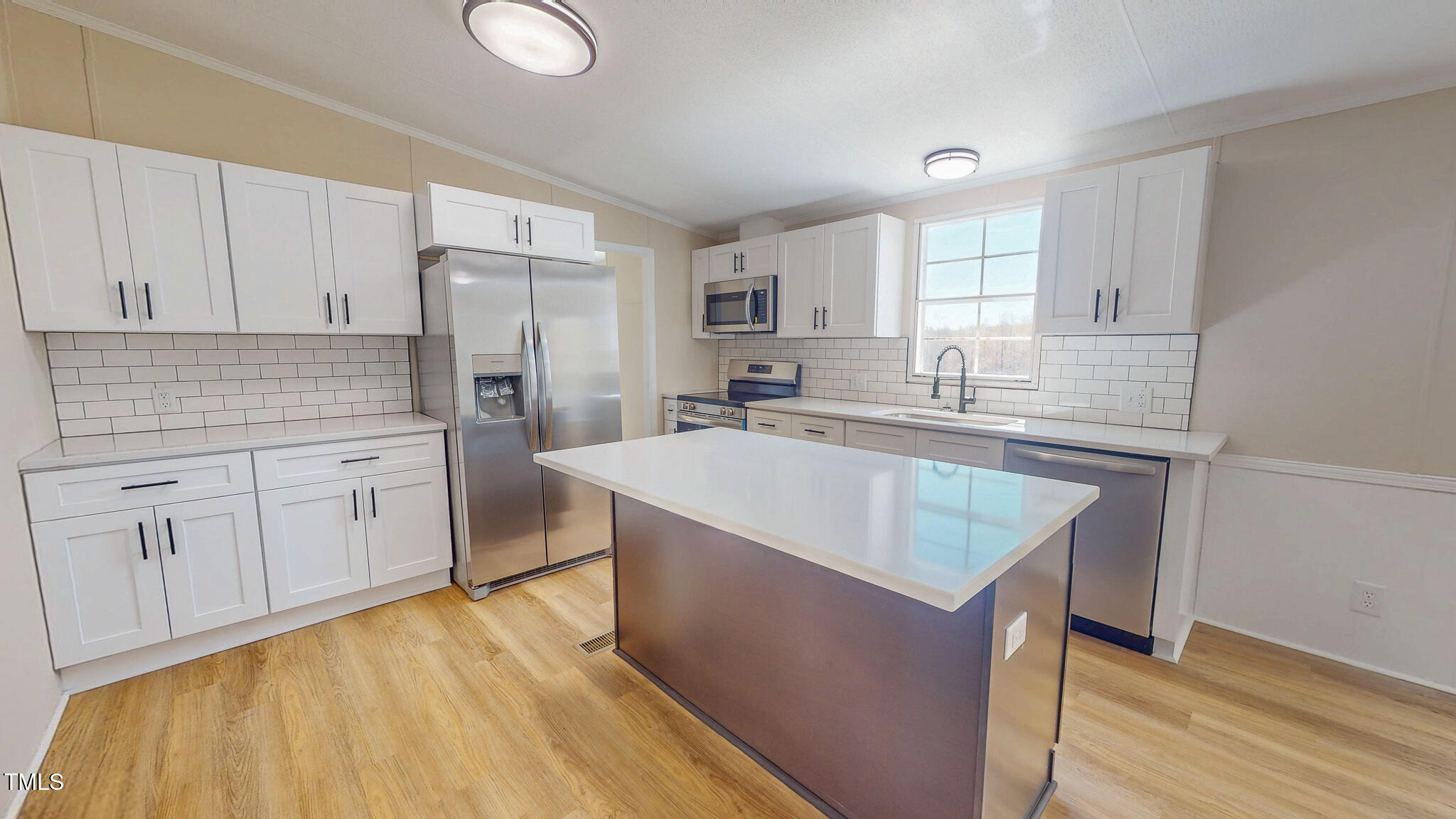 210 Holloway Road Roxboro, NC 27573 - Photo 4 of 44 a kitchen with kitchen island granite countertop a sink stove and refrigerator