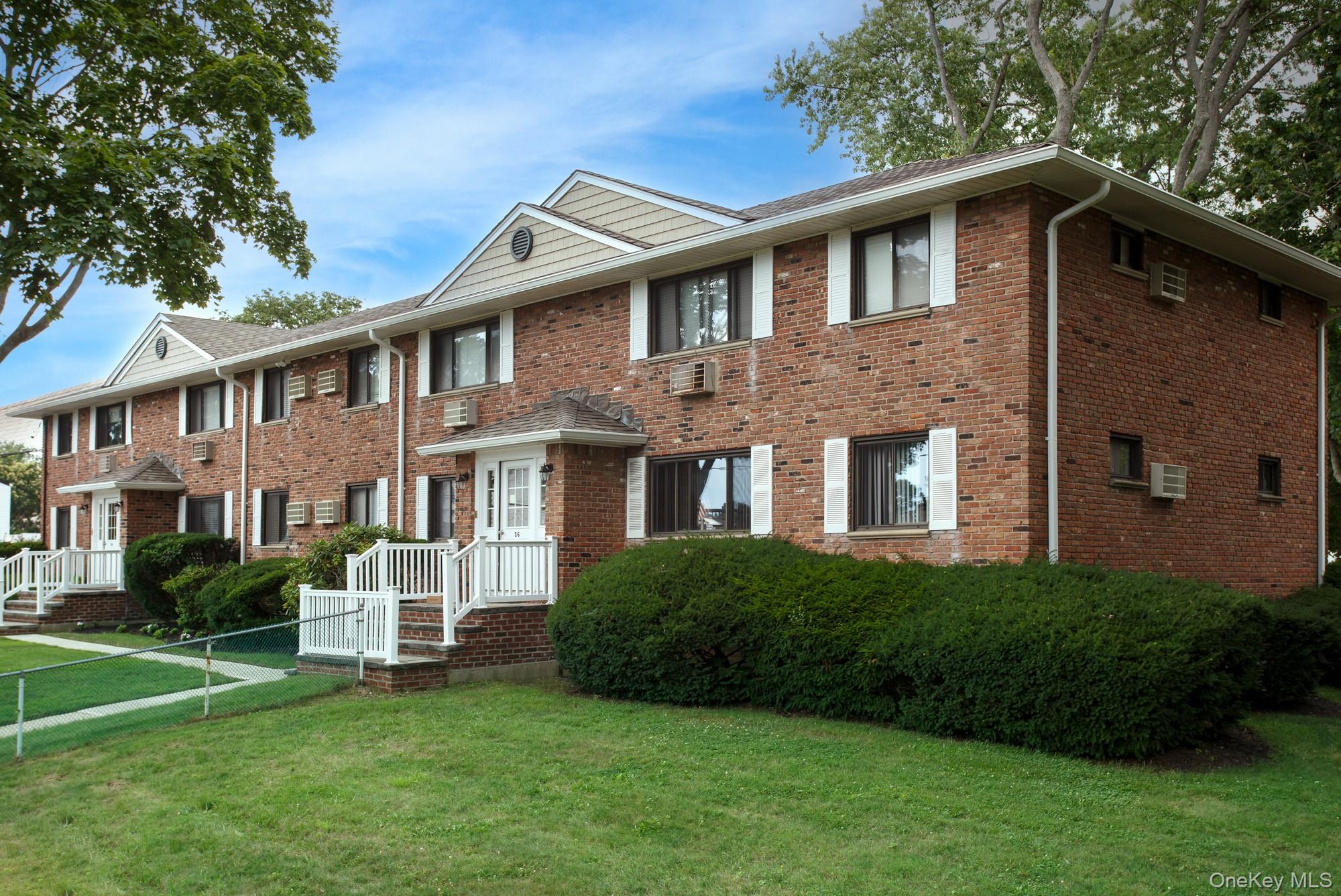 20 Perry Street, Unit 1 Lindenhurst, NY 11757 - Photo 1 of 1 a front view of a house with a garden