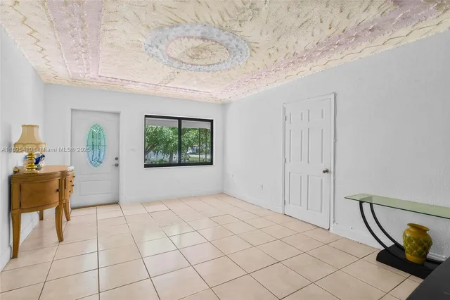 a kitchen with stainless steel appliances kitchen island granite countertop a sink a stove a microwave a dining table and chairs