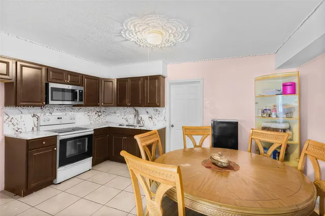 a kitchen with stainless steel appliances granite countertop a sink stove and microwave