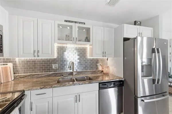 a view of a kitchen with a stove a microwave and furniture