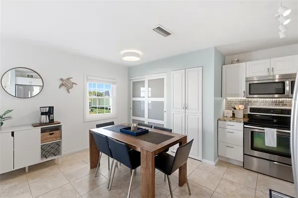 a kitchen with kitchen island granite countertop a sink stove and refrigerator