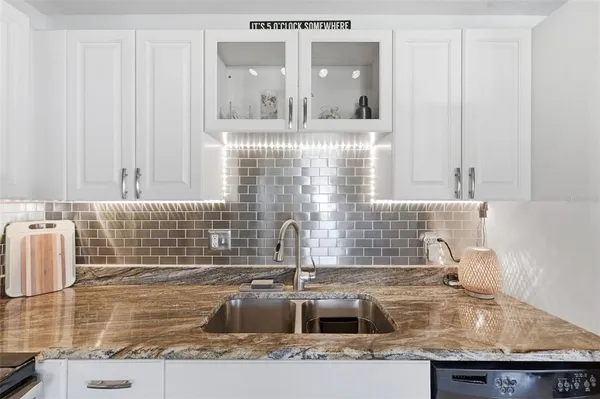 a bathroom with a granite countertop sink mirror vanity and toilet
