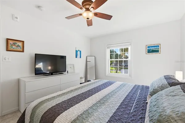a bedroom with a bed and a flat screen tv