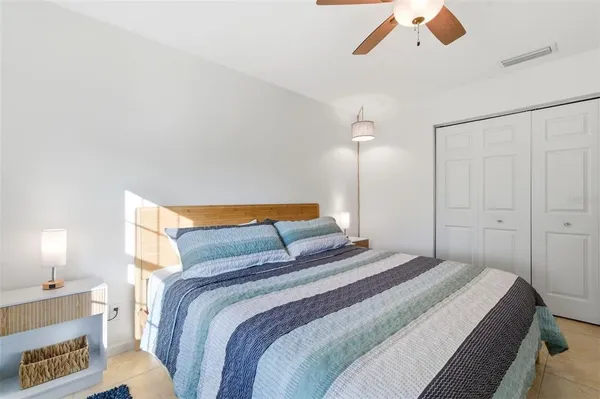 a bedroom with a bed and painting on the wall
