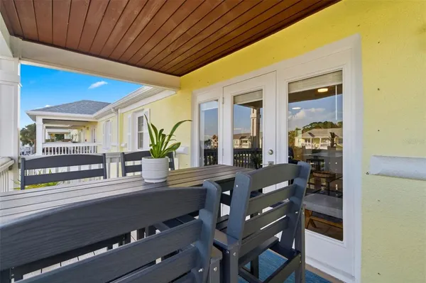 a view of a balcony with chairs and wooden floor