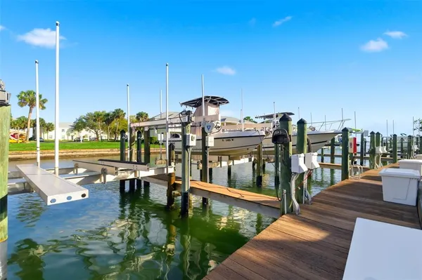 a view of swimming pool with outdoor seating and lake view