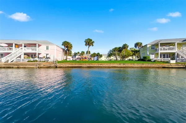 an aerial view of residential houses with outdoor space and seating