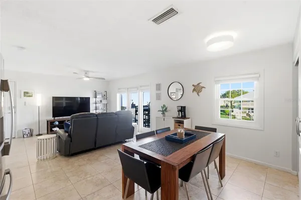 a living room with furniture a window and a flat screen tv