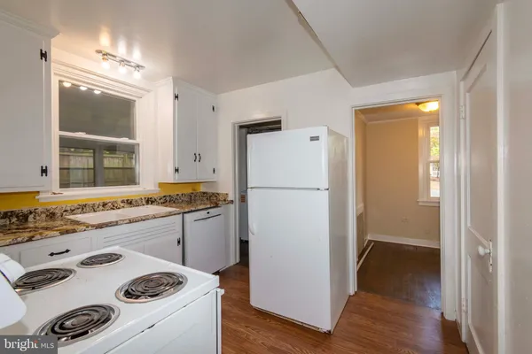 a kitchen with a stove and a refrigerator
