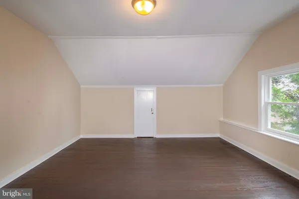 an empty room with a window and a lamp
