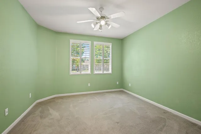a view of an empty room with a fan