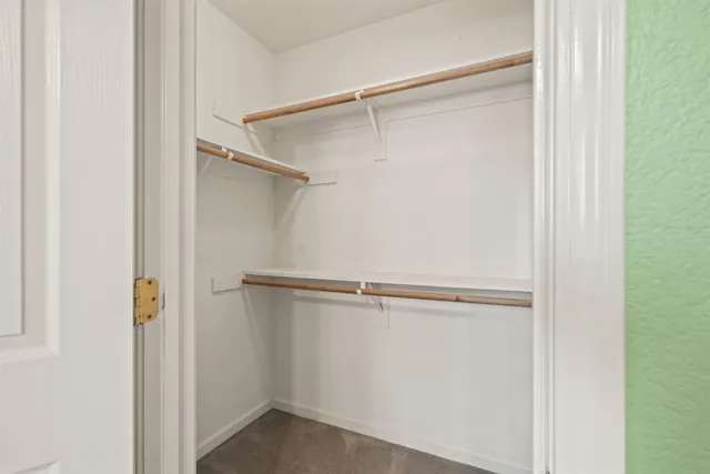a bathroom with a granite countertop sink a toilet and a mirror