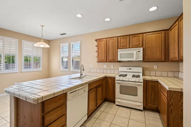 a kitchen with a stove sink and microwave