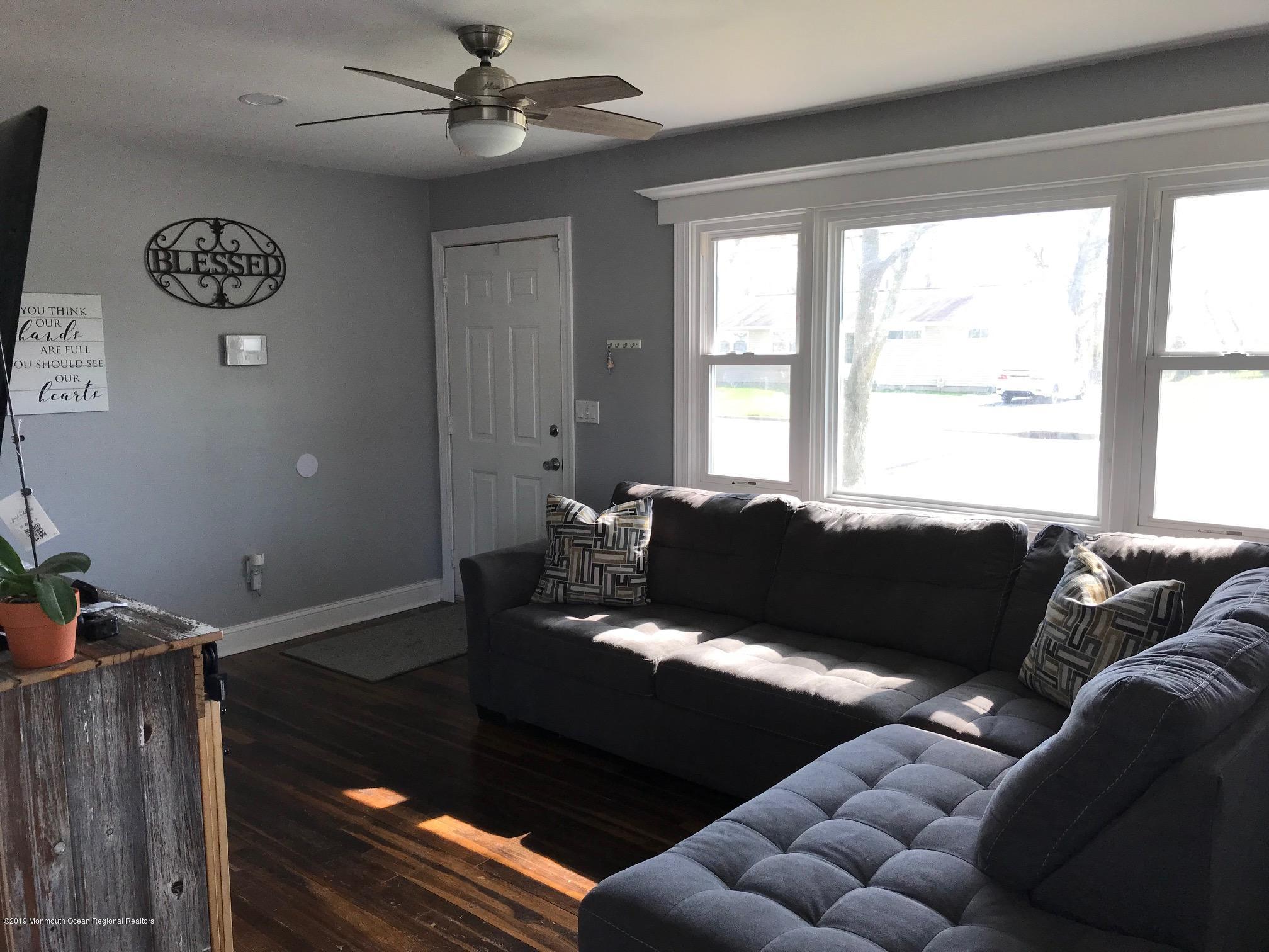 14 Chain Boulevard Bayville, NJ 08721 - Photo 2 of 17 a living room with furniture and a floor to ceiling window