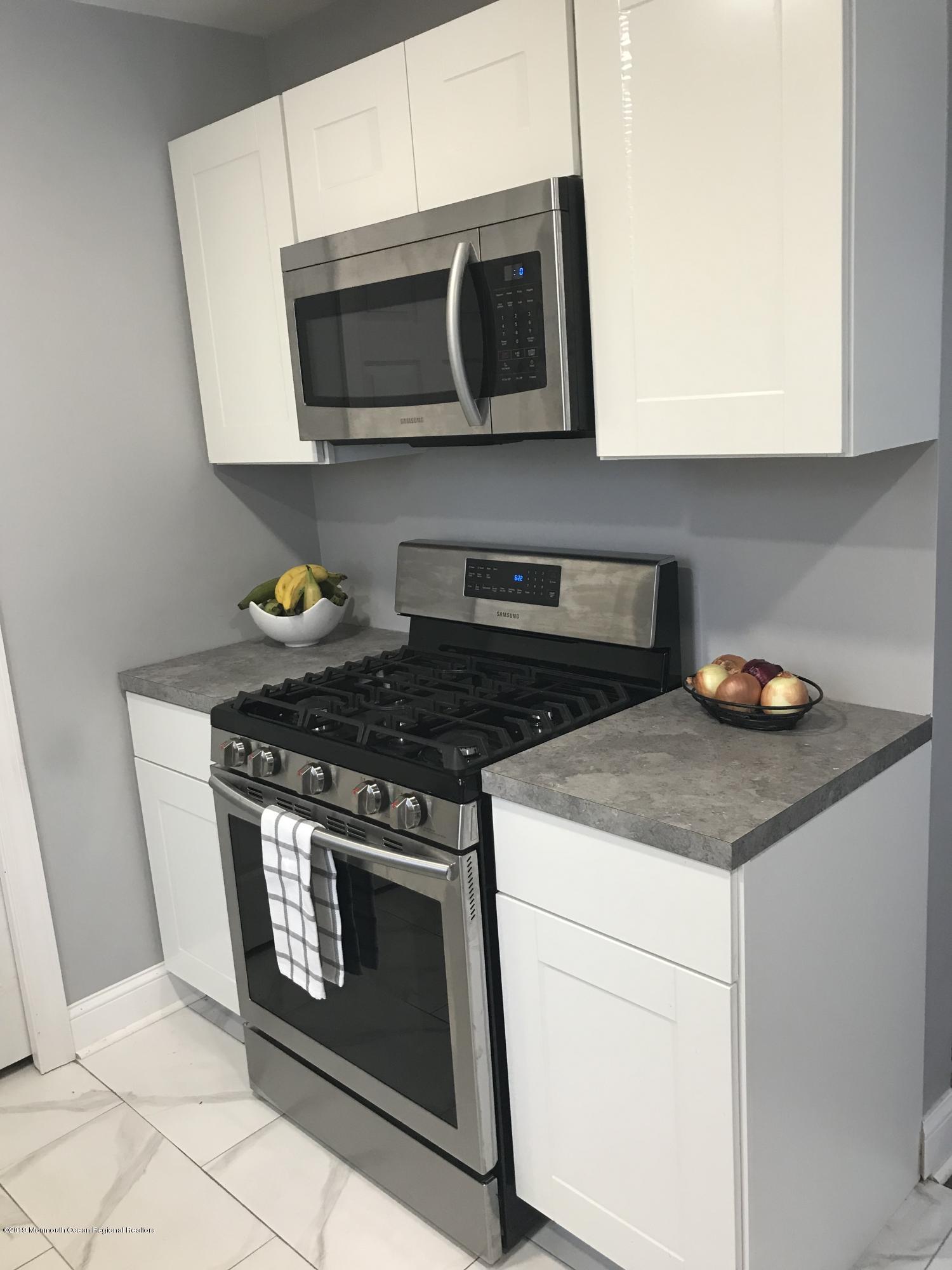 14 Chain Boulevard Bayville, NJ 08721 - Photo 14 of 17 a stove top oven sitting inside of a kitchen