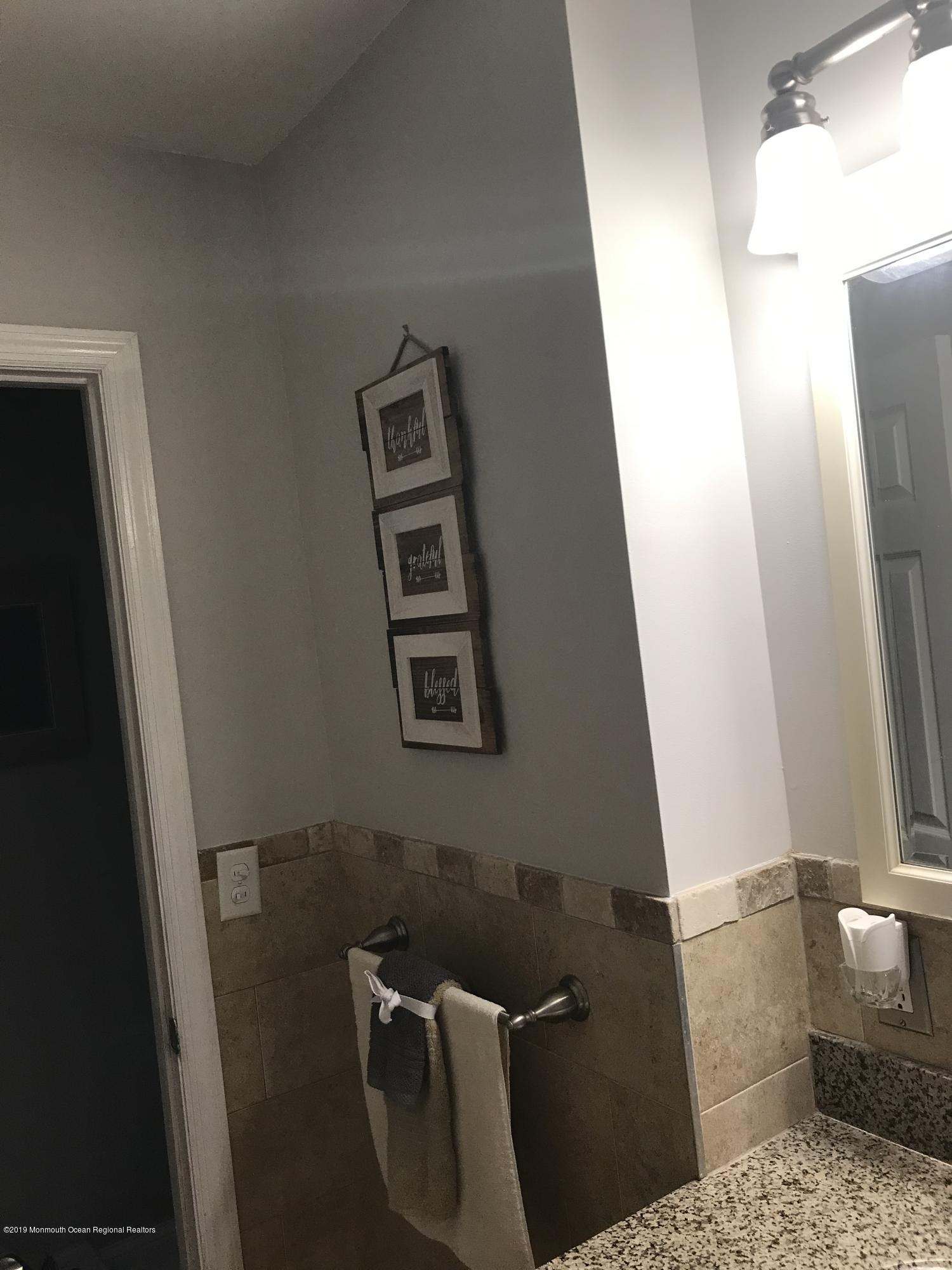 14 Chain Boulevard Bayville, NJ 08721 - Photo 16 of 17 a bathroom with a sink and a mirror