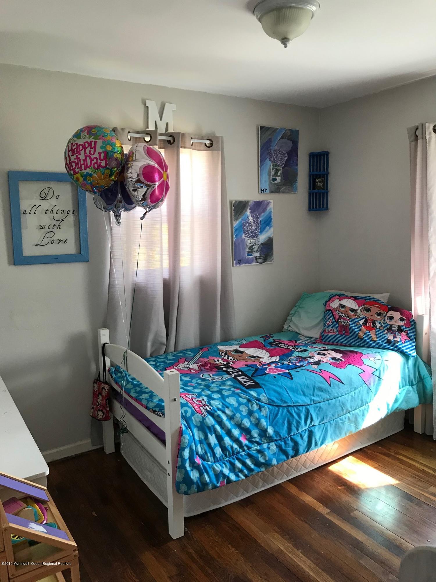 14 Chain Boulevard Bayville, NJ 08721 - Photo 3 of 17 a bedroom with a bed and a window