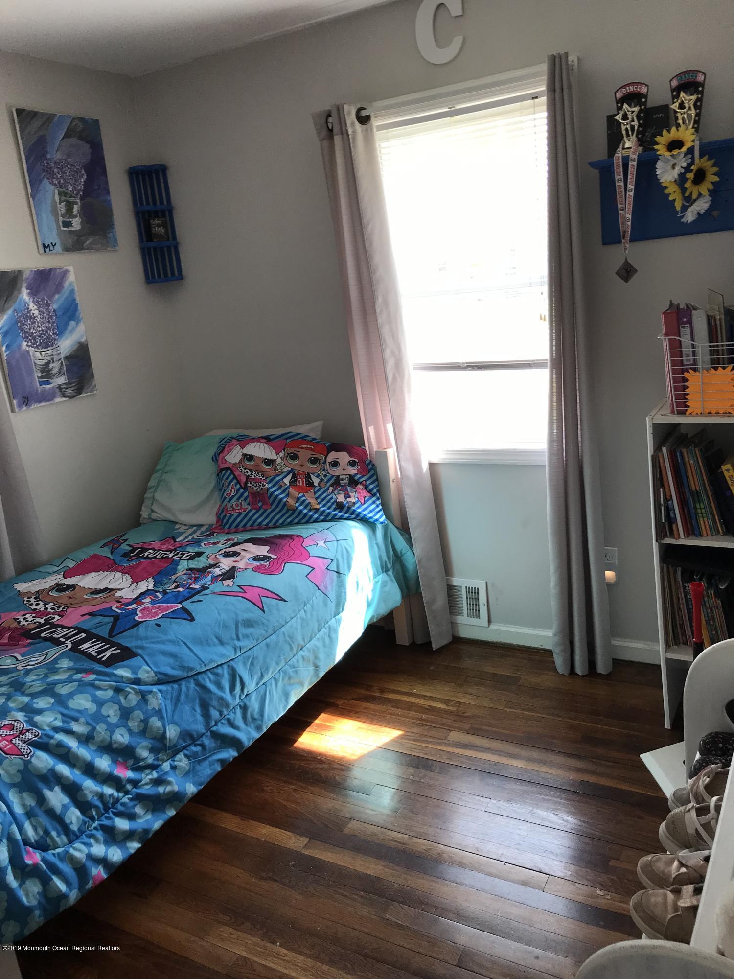 14 Chain Boulevard Bayville, NJ 08721 - Photo 6 of 17 a bedroom with a bed and wooden floor